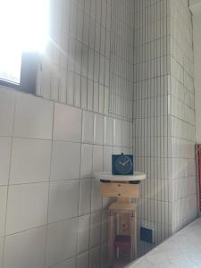 a clock on a shelf in a tiled wall at Wontonmeen in Hong Kong