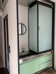 a bathroom with a sink and a mirror at Wontonmeen in Hong Kong