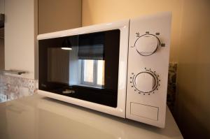 a microwave oven sitting on top of a counter at Kyiv Rouge Apartment in Kyiv