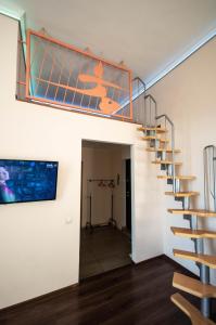 a staircase in a house with a painting on the wall at Kyiv Rouge Apartment in Kyiv