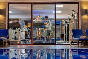 two people in a gym with a swimming pool at Sealife Family Resort Hotel in Antalya