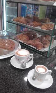 a counter with two cups of coffee and pastries at B&B Trinacria Modica in Modica
