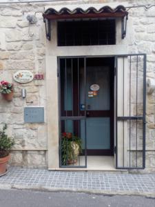 a front door of a stone building with a blue door at B&B Trinacria Modica in Modica