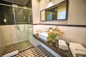 a bathroom with a sink and a shower at Hotel Afrodyta Business & Spa in Radziejowice