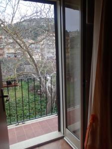 a sliding glass door with a view of a tree at B&B Trinacria Modica in Modica
