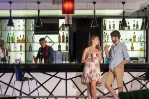 a man and a woman standing at a bar at Sealife Family Resort Hotel in Antalya