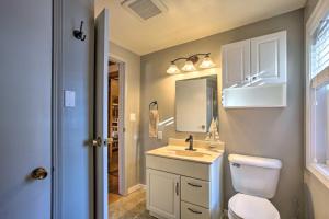 a bathroom with a sink and a toilet and a mirror at 4 Season, Waterfront Houghton Lake House with Dock! in Houghton Lake +16 photos