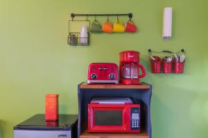 a red microwave sitting on a shelf next to a kitchen at Hainsley Apartments - Walk to Wilton Drive in Fort Lauderdale