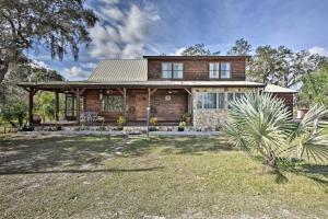 a wooden house with a large yard in front of it at 40-Acre Farm with Animals and Fishing in Sebring! in Sebring