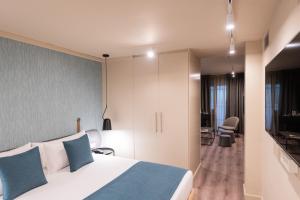 Posteľ alebo postele v izbe v ubytovaní Atenea Rekord Suites