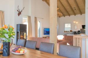 A television and/or entertainment centre at Grossglockner Chalets Zell am See