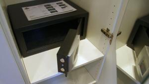 a microwave oven sitting on top of a cabinet at Haus Dünenbake, Ferienwohnung Strandpeter Wohnung 13 in Sankt Peter-Ording