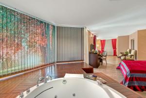 a bathroom with a bath tub in a room at Sealife Family Resort Hotel in Antalya