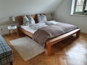 a bedroom with a large bed with a wooden frame at Ferienhaus Schütt in Zempin