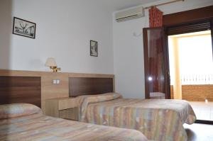 Postel nebo postele na pokoji v ubytování LABELLA - Hostal Rural Restaurante