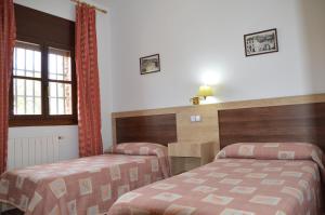 Postel nebo postele na pokoji v ubytování LABELLA - Hostal Rural Restaurante
