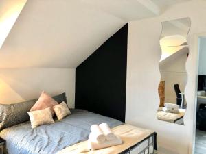 a bedroom with a bed with two towels on it at BELMONT Apartments in Liverpool