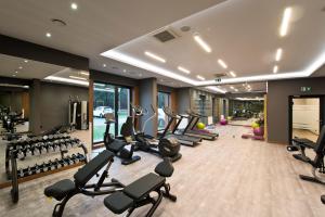 a gym with a lot of treadmills and ellipticals at Love In Gdańsk AON Apartments in Gdańsk