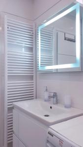 a white bathroom with a sink and a mirror at Holiday Apartment VILLA BIANCA in Pazin