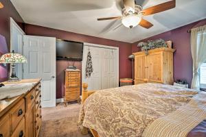 a bedroom with a bed and a ceiling fan at Mashpee Home with Dock on Popponesset Bay! in Mashpee
