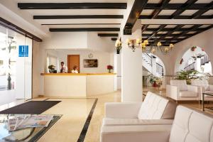 
a living room filled with furniture and a large window at Villa Flamenca in Nerja
