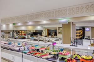 a large kitchen with a bunch of food on display at Sealife Family Resort Hotel in Antalya