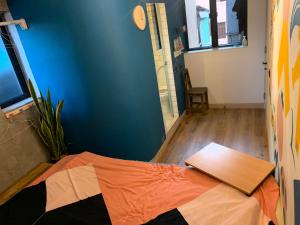 a room with a bed and a wooden table at Wontonmeen in Hong Kong