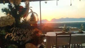 a christmas tree in a dining room with the sunset at Ao Luek Panoramic Pool-SHA Plus in Ao Luk