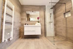 a bathroom with a white sink and a shower at Residence ACQUA LINDA Porticcio in Porticcio