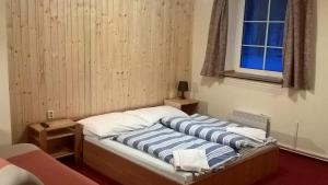 Postel nebo postele na pokoji v ubytování Studia Pod Lysou
