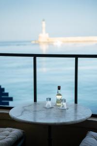 a table with a glass of water and a glass of wine at Porto Antico in Chania