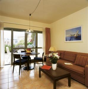 a living room with a couch and a table at Hapimag Ferienwohnungen Puerto de la Cruz in Puerto de la Cruz