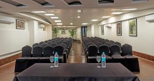 a conference room with chairs and two bottles of water on a table at Lemon Tree Premier, Rishikesh in Rishīkesh +57 photos