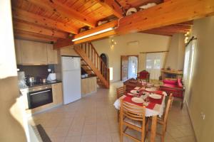 a kitchen and dining room with a table and chairs at Nonda's Mansion in Falasarna