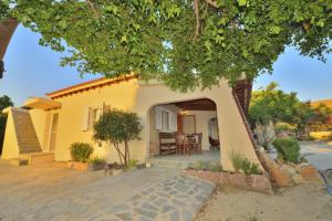 a small house with a tree in front of it at Nonda's Mansion in Falasarna