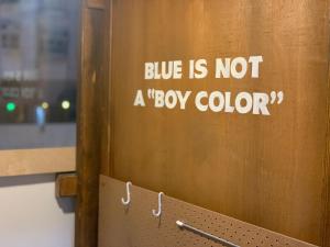 a door with a sign that says blue is not a box color at Wontonmeen in Hong Kong