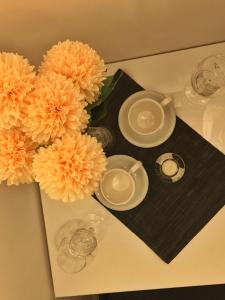 a table with two plates and flowers on it at Labroski Apartments in Ohrid