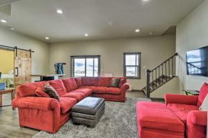 a living room with a red couch and chairs at Majestic Granby Home with Hot Tub, Deck and Views! in Granby