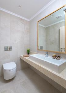 a bathroom with a sink and a toilet and a mirror at Villa Akrotiri in vlicha +9 photos