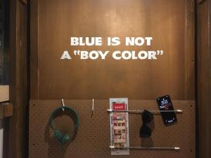 a sign on a wall that says blue is not a box color at Wontonmeen in Hong Kong