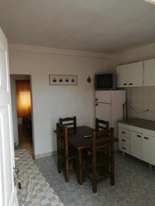 a kitchen with a table and chairs and a refrigerator at Casa duplex Frente AL Mar familiar Depto A in Mar del Plata +22 photos