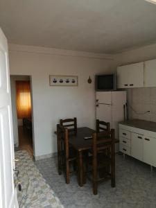 a kitchen with a table and chairs and a refrigerator at Casa duplex Frente AL Mar familiar Depto A in Mar del Plata