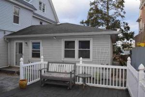 a house with a white fence and a bench at La Casita Bonita Near NYC in Yonkers