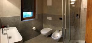 a bathroom with a toilet and a sink and a shower at Hotel san Vitale in Bormio