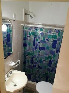 a bathroom with a sink and a shower curtain at Casa duplex Frente AL Mar familiar Depto A in Mar del Plata