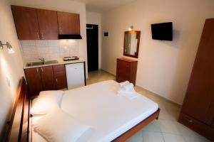 a small room with a bed and a kitchen at Malamatenia House in Sarti