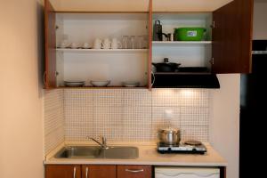 a kitchen with a sink and a counter top at Malamatenia House in Sarti +14 photos