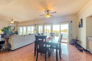 a dining room with a table and a couch at Villa 12 at Mara Laguna - Gold Standard Certified in San Pedro