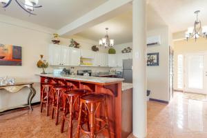 a kitchen with a island with bar stools at Villa 12 at Mara Laguna - Gold Standard Certified in San Pedro