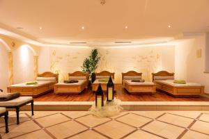 a large room with four beds in it at Aktiv & Wellnesshotel Zentral in Prato allo Stelvio